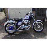 A 1977 Harley-Davidson Sportster XLH1000, registration number UPP 529R, blue and cream.