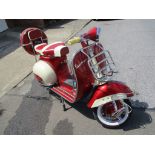 A 1962 Piaggio Vespa 150, unregistered, maroon and cream.