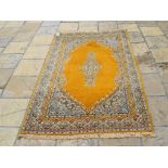 An Eastern medallion rug, having a yello