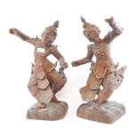 A pair of Indonesian carved wood dancing figures, slight loss, approx.