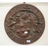 A carved oak armorial panel, with a motto and dated 1883,