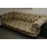 A late Victorian/Edwardian upholstered three seater Chesterfield settee