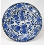 A Chinese porcelain charger, decorated stylised flowers and foliage in underglaze blue, repaired,