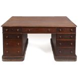 A late Victorian/Edwardian partners mahogany desk, each side having an arrangement of nine drawers,