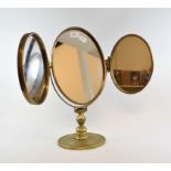 A brass triple oval mirror,