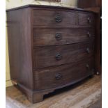 An early 19th century bow front mahogany chest, on two short and three graduated long drawers,