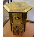 A small black lacquered table, of hexagonal form, with gilt decoration, 30.