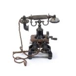 An early 20th century 'Eiffel Tower' skeleton telephone, on a shaped cast iron base,