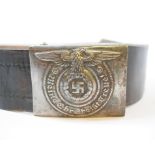 A German World War II buckle, on a belt, a gas mask carrier, a water bottle, a harness,