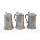 Three pewter tankards and covers, with presentation inscriptions,