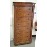 A walnut Wellington chest, having eight long drawers,