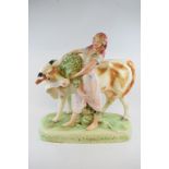 A large Continental pottery group, of a maiden with a cow,