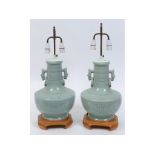 A pair of Chinese celadon ground vases, with ring handles, adapted for electricity,