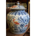 A Chinese vase and cover, decorated fish and foliage,