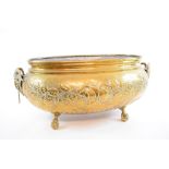 A Victorian oval brass planter, having goat mask handles and embossed foliage decoration,