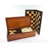 A games compendium, comprising chess, draughts and backgammon pieces, cased,