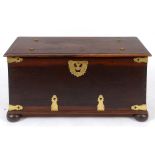A Colonial hardwood chest, with brass mounts, on bun feet,
