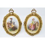 A pair of late 19th century oval porcelain plaques, decorated court figures,