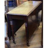 A 19th century mahogany drop leaf table, on tapering turned legs,