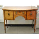 An early 19th century inlaid mahogany bow front sideboard, on tapering square legs,