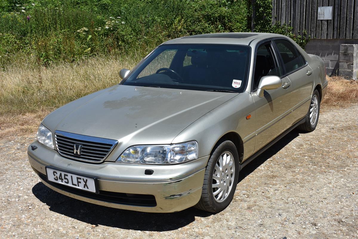 A 1998 Honda Legend Acura CL, registration number S45 LFX, gold.