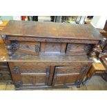 An inlaid oak court cupboard, carved flo