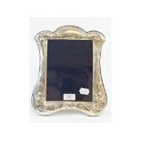 A silver photograph frame, decorated sty