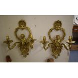 A pair of gilt metal two branch wall lig