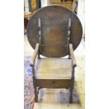 An oak chair table, with a circular top,