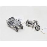 A silver novelty model car, 3 cm high an