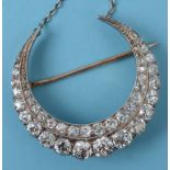 A Victorian diamond set crescent brooch/
