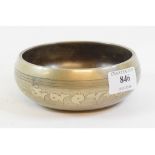 A Tibetan silver coloured metal inlaid b