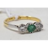 An 18ct gold, emerald and diamond three