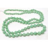 A string of graduated green jade beads