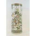 A Chinese porcelain cylindrical vase, decorated a bird perched on a flowering tree, cracked, 36.5 cm