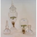 A pair of glass brandy dispensers, one with base detached, 34 cm high (2)