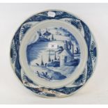 A 19th century Dutch Delft charger, decorated dwellings, slight restoration, 35.5 cm diameter