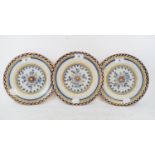 A set of three 19th century Dutch Delft polychrome plates, with floral decoration, 23 cm diameter