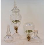 A pair of glass brandy dispensers, one with base detached, 34 cm high (2)