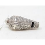 A silver novelty whistle/vinaigrette, with embossed decoration