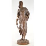 A late 19th/early 20th century bronze figure, of a lady carrying a scimitar sword, on a circular