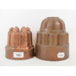 A 19th century copper jelly mould, of castellated form, 12 cm high, and another similar, 15 cm