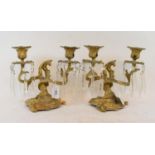 A pair of gilt metal candelabra, with glass drops, 19 cm high (2)