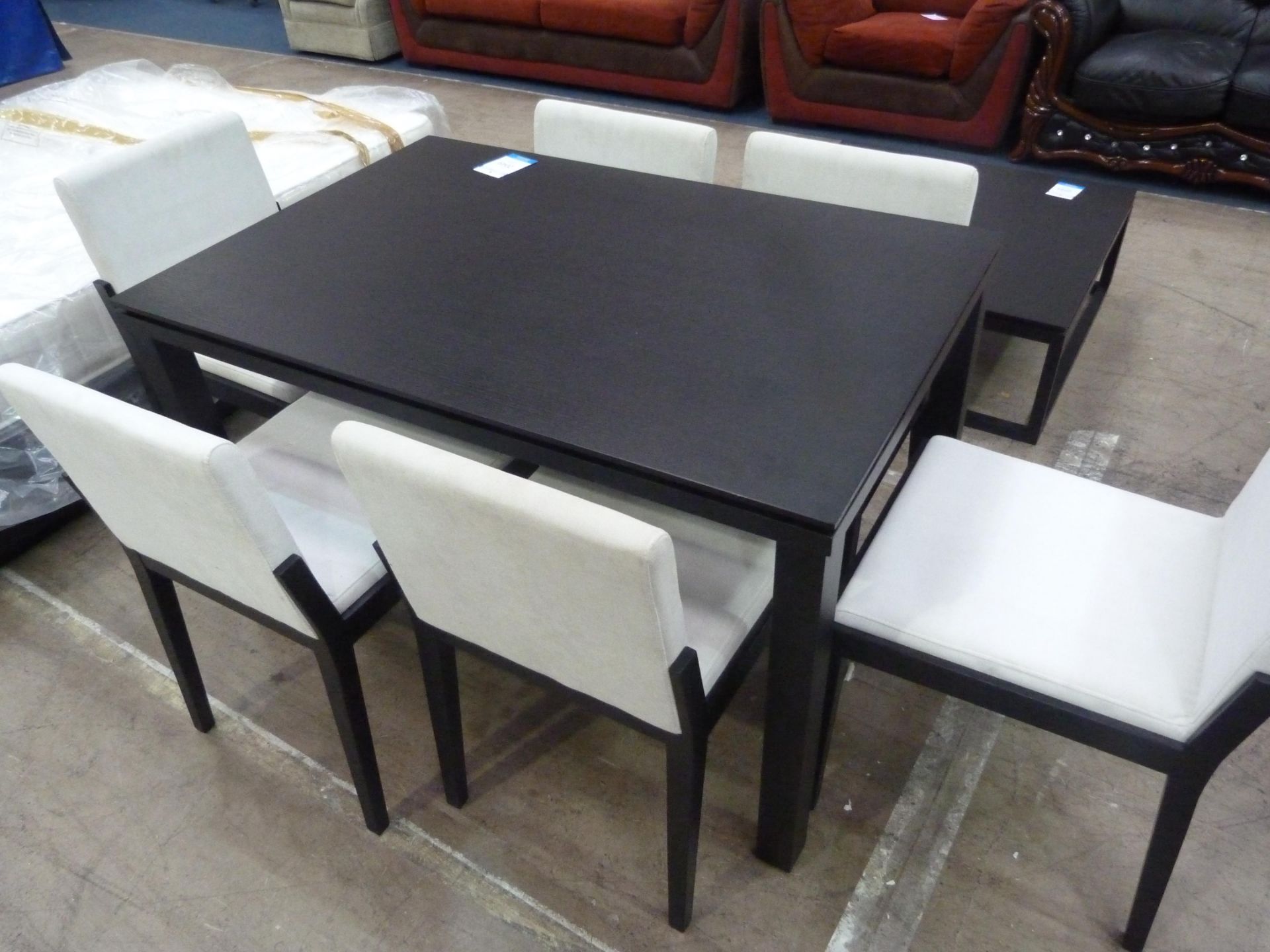 A Dark Dining Table (H75cm, W120cm, D80cm) with Six matching Chairs featuring Cream Upholstered