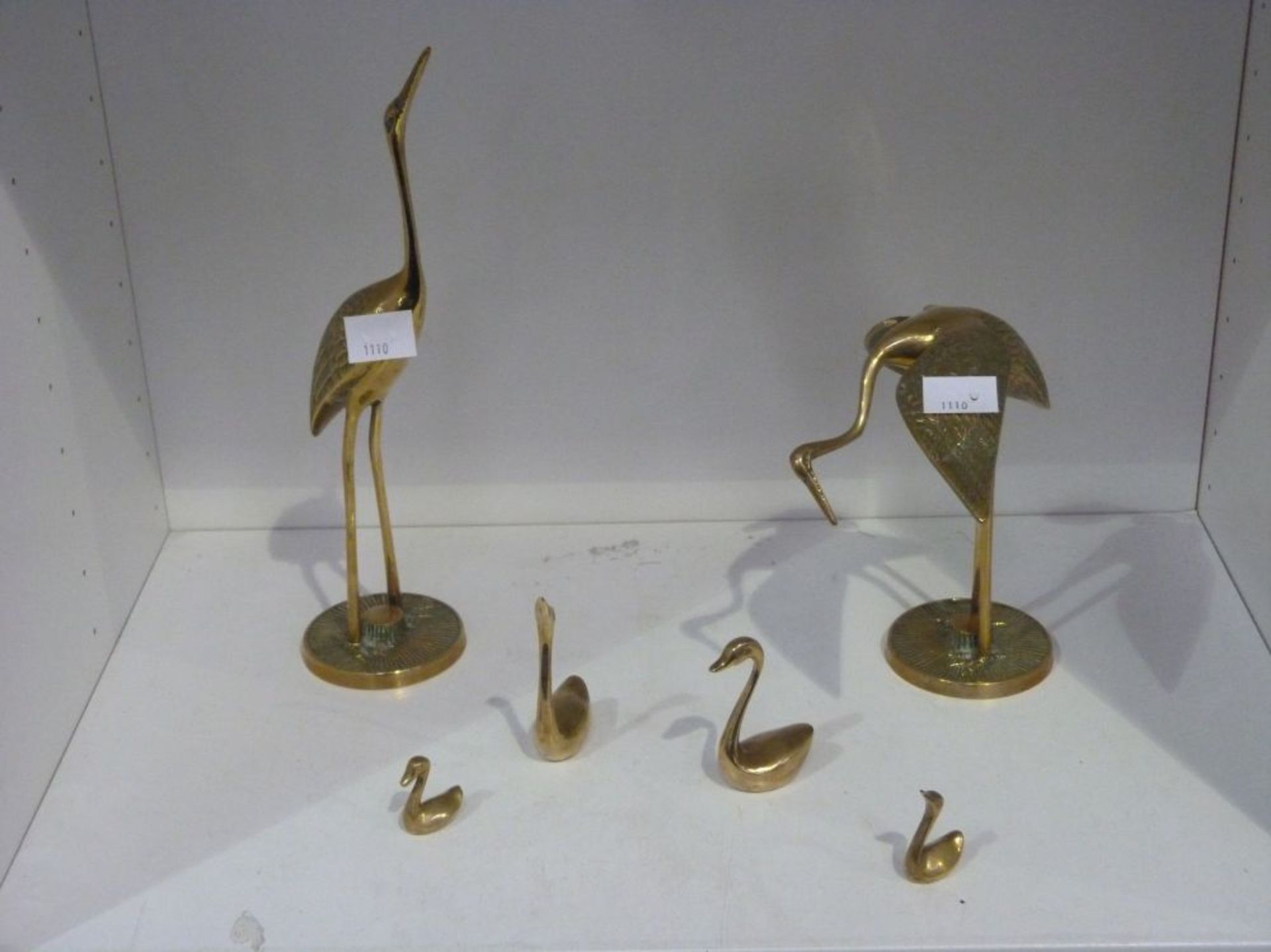Two Solid Brass Herons, together with four Solid Brass Swans (6) (Est. £20-£30)