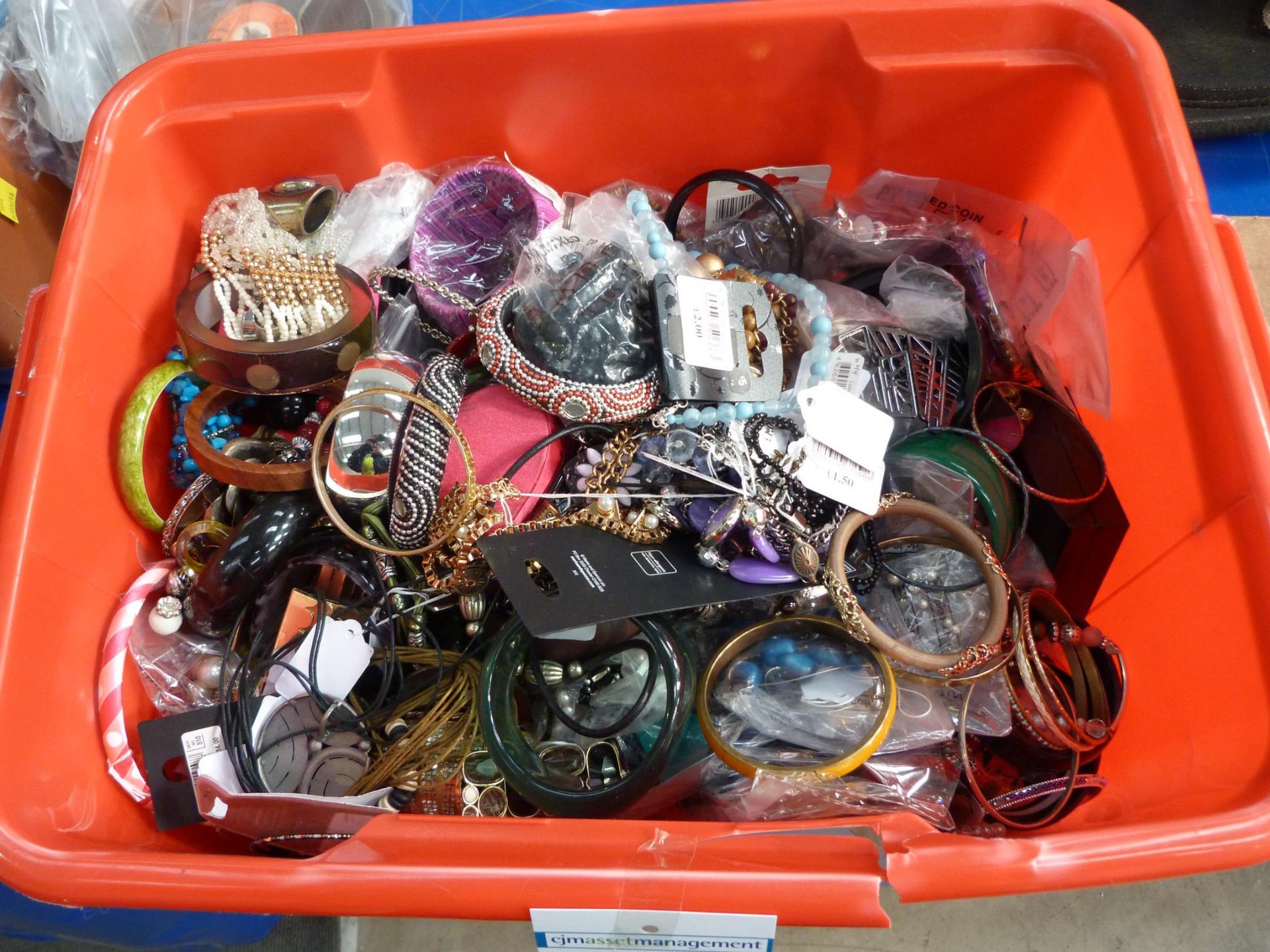 A box containing a selection of assorted Costume Jewellery. This lot is being sold without an