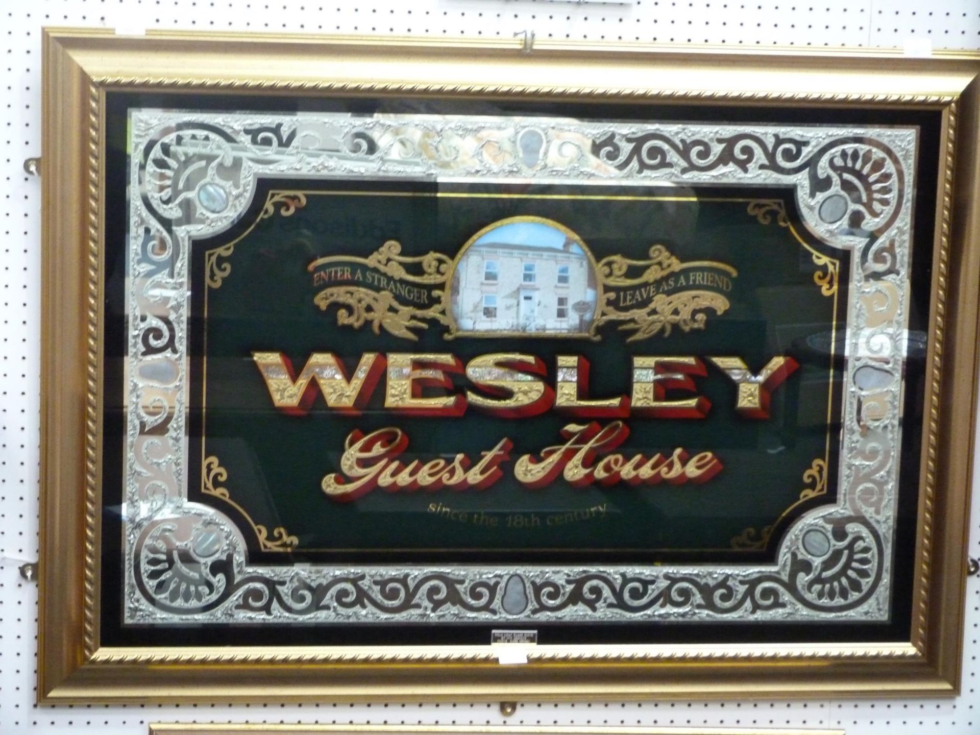 A heavily decorated 'chipped & gilded' Glass Panel Mirror of Wesley Guest House. This Panel includes