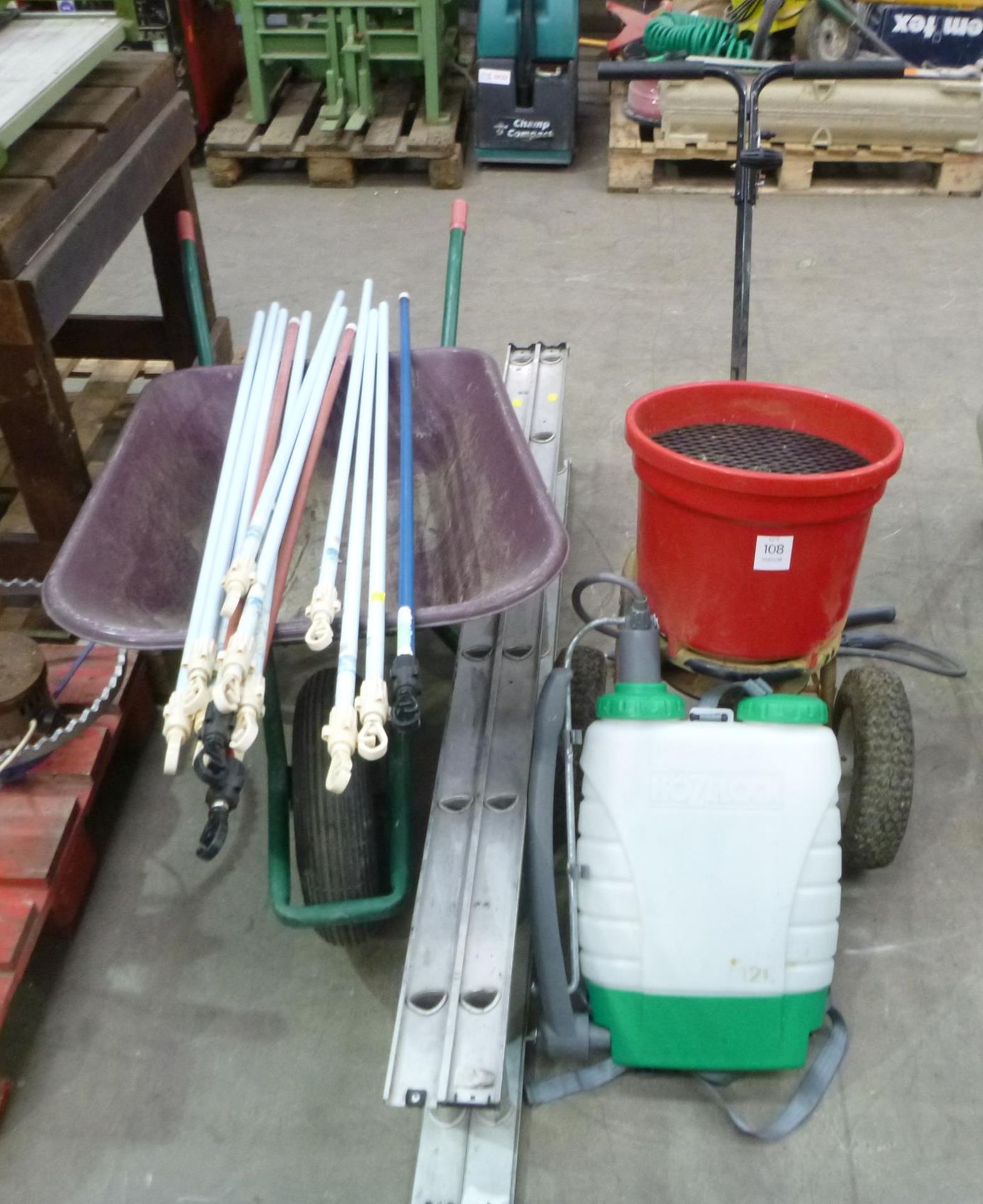 A Wheeled Salt Spreader, Back Pack Sprayer, Wheel Barrow, 12 Rung Extendable Ladder and Mop