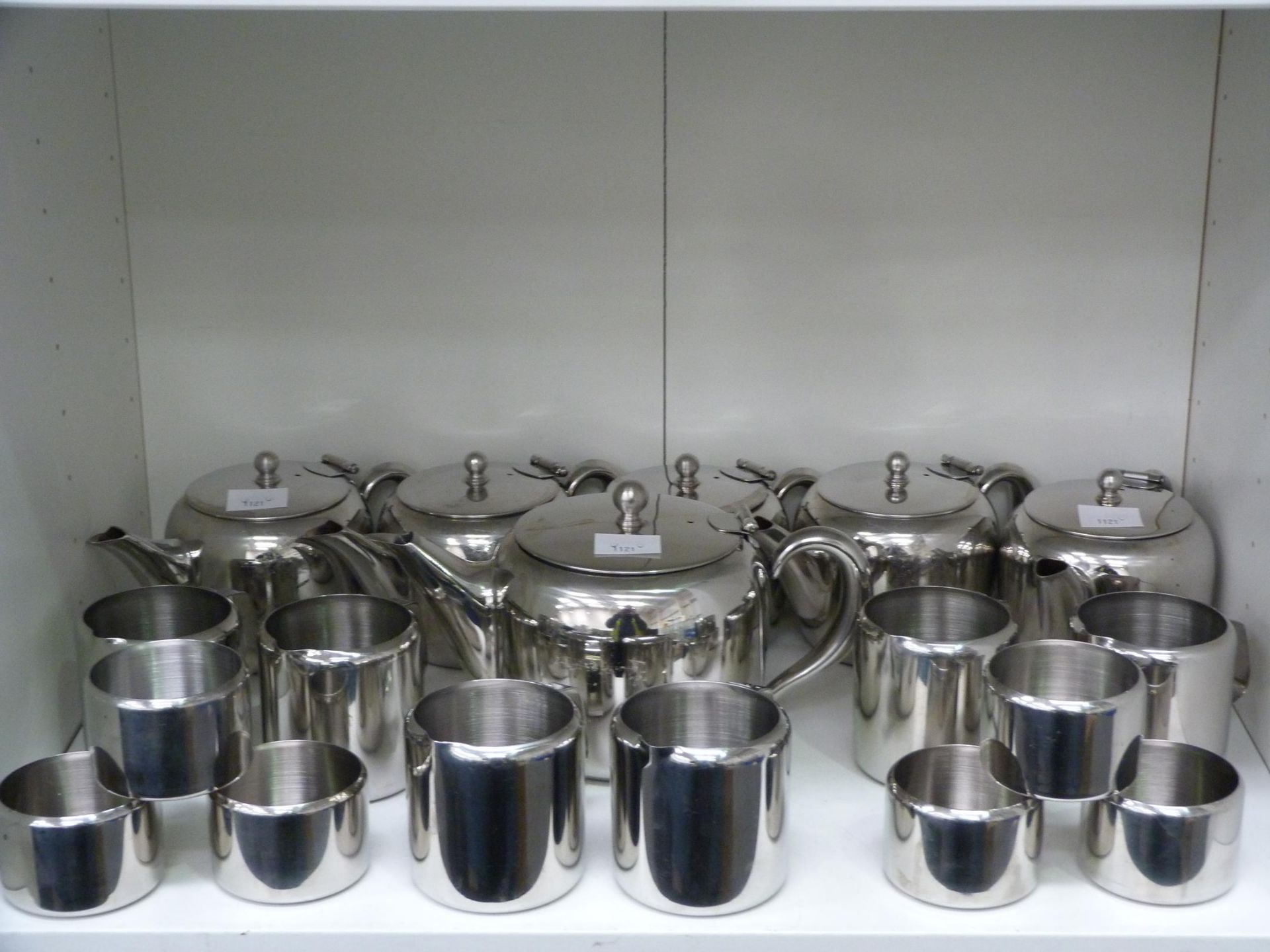 Four shelves to contain a selection of stainless steel tea/coffee items, including teapots, jugs