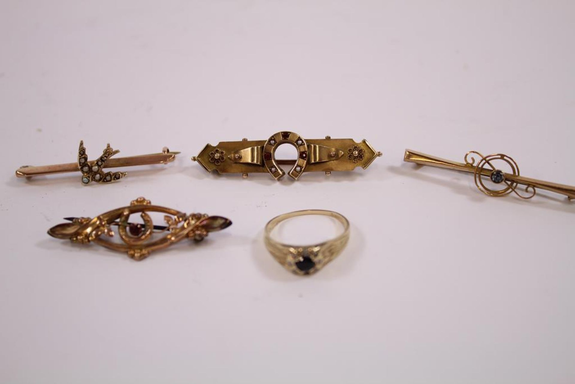 Four various 9ct Gold Brooches, Gross weight 6.7gms together with a worn Sapphire set Ring. (Est.£